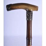 A 19TH CENTURY MIDDLE EASTERN CARVED RHINOCEROS HORN HANDLED PARASOL. 90 cm long.