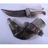 A 19TH CENTURY MIDDLE EASTERN OMANI CARVED RHINOCEROS HORN HANDLED JAMBIYA DAGGER with white metal r