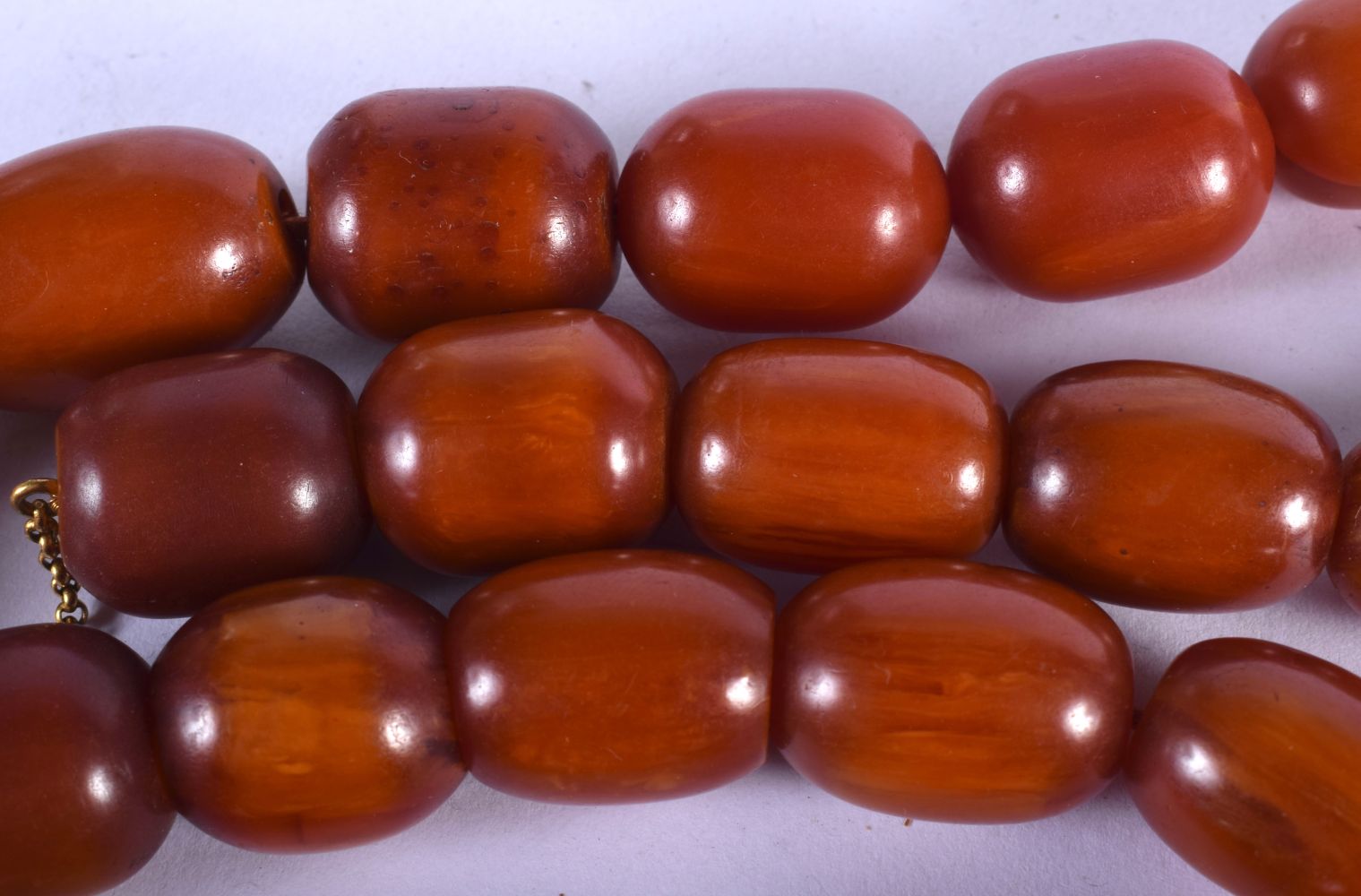 AN EARLY 20TH CENTURY AMBER BAKELITE CATALIN NECKLACE. 137 grams. 64 cm long, largest bead 2 cm x 1. - Image 2 of 2