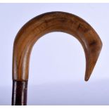 A 19TH CENTURY MIDDLE EASTERN CARVED RHINOCEROS HORN HANDLED WALKING CANE. 88 cm long.