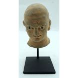 A Clay head of a Egyptian male on a stand 12cm (2).