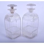 A NEAR PAIR OF GEORGE III CUT GLASS DECANTERS AND STOPPERS. 19 cm high.