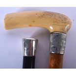 A 19TH CENTURY CONTINENTAL CARVED IVORY HANDLED WALKING CANE together with a silver mounted ebony ca