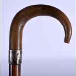 A 19TH CENTURY MIDDLE EASTERN CARVED RHINOCEROS HORN HANDLED WALKING CANE. 80 cm long.