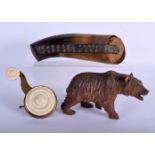 AN ANTIQUE BAVARIAN BLACK FOREST BEAR together with a powder horn etc. Largest 29 cm long. (3)