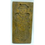 An antique wooden biscuit mould in the form of a bear. 22 x 11cm.