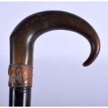 A 19TH CENTURY MIDDLE EASTERN CARVED RHINOCEROS HORN HANDLED WALKING CANE. 90 cm long.