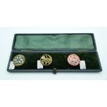 A cased set of vintage metal and enamelled buttons 2.5cm. (4).
