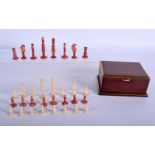 A 19TH CENTURY ANGLO INDIAN CARVED AND STAINED TRAVELLING BONE CHESS SET within a fitted mahogany bo