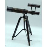 A small bronze telescope on a tri pod 31cm.