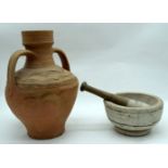 A large clay twin handled urn together with a stone pestle and mortar 33cm (2).