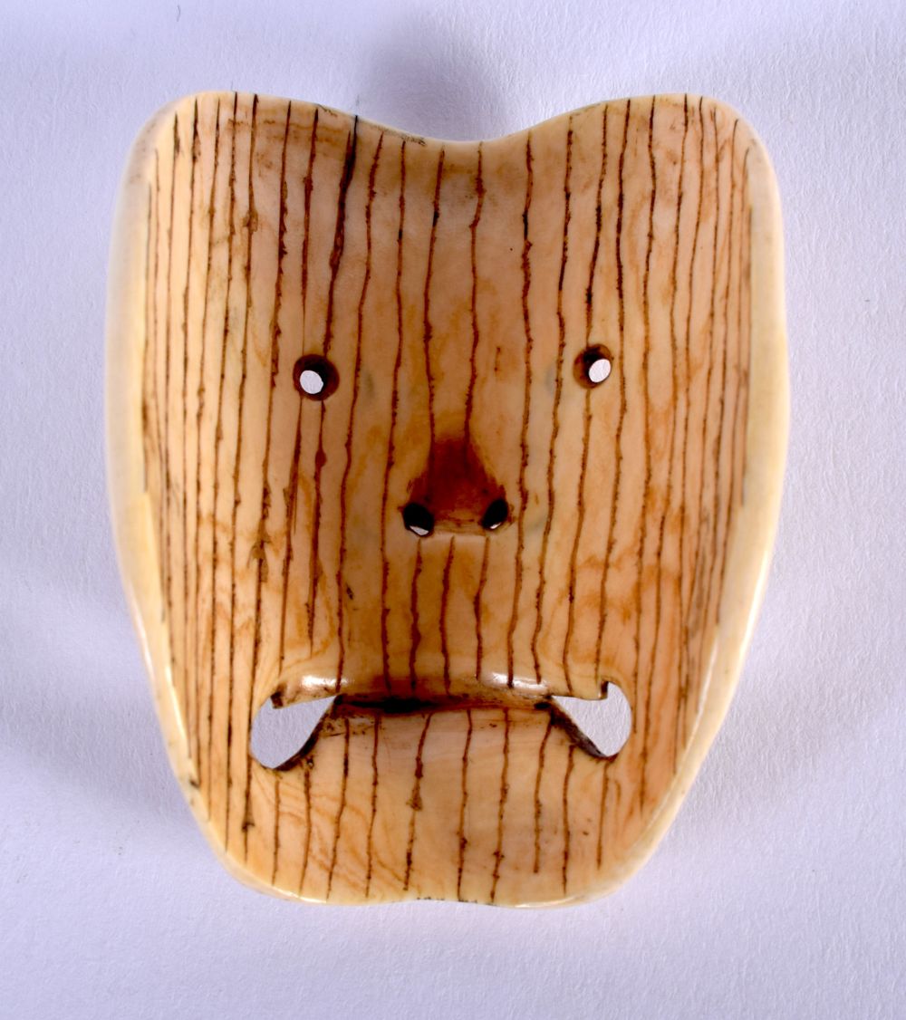 A 19TH CENTURY JAPANESE MEIJI PERIOD CARVED IVORY NOH MASK modelled as a scowling face. 4.5 cm x 3.5 - Image 2 of 2