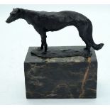 A bronze model of a dog set on a polished stone plinth 8 x 16cm.