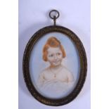 AN EARLY 20TH CENTURY EUROPEAN PAINTED IVORY PORTRAIT MINIATURE depicting a girl wearing a gold neck