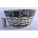 A LARGE 19TH CENTURY BRITISH ARTS AND CRAFTS POTTERY BOWL painted with berries, vines and trailing