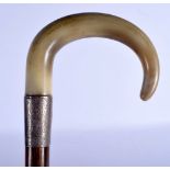 A 19TH CENTURY MIDDLE EASTERN CARVED RHINOCEROS HORN HANDLED WALKING CANE. 90 cm long.