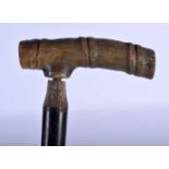 A 19TH CENTURY MIDDLE EASTERN CARVED RHINOCEROS HORN HANDLED WALKING CANE. 88 cm long.