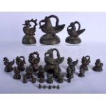 A COLLECTION OF 19TH CENTURY SOUTH EAST ASIAN BRONE OPIUM WEIGHTS of unusual graduated form. Largest