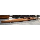 A lovely vintage cedar wood canoe together with paddles, trophies and medals.