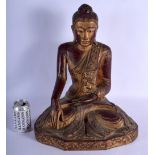 A SOUTH EAST ASIAN CARVED AND LACQUERED FIGURE OF A BUDDHA upon a scrolling base. 48 cm x 24 cm.
