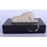 A GEORGE III CARVED MARBLE LION upon a black marble base. 15 cm x 8 cm.