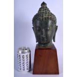 A 19TH CENTURY THAI SOUTH EAST ASIAN BRONZE BUST OF A BUDDHA upon a hardwood base. Bronze 19 cm x 13