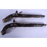 A PAIR OF 19TH CENTURY SYRIAN OTTOMAN TURKISH DUELLING PISTOLS with silver inlaid foliage and vines.