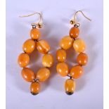 A PAIR OF VINTAGE BUTTERSCOTCH AMBER EARRINGS. 3.5 cm long.