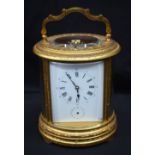 AN ANTIQUE REPEATING BRASS CARRIAGE CLOCK. 19 cm high inc handle.