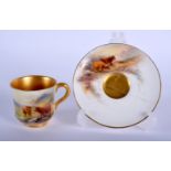 A ROYAL WORCESTER COFFEE CUP AND SAUCER C1912, painted by Harry Stinton. Saucer 9.5 cm diameter.
