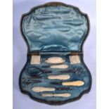 AN ART NOUVEAU FRENCH CARVED IVORY SEWING SET decorated with maidens. (qty)