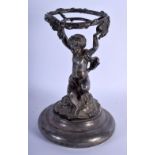 AN UNUSUAL 19TH CENTURY ENGLISH SILVER PLATED FIGURAL TABLE CENTREPIECE formed as a seated putti. 30