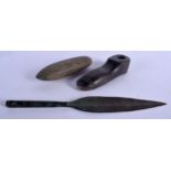 AN UNUSUAL ANTIQUITY BRONZE SPEAR TIP together with a stone pestle and an unusual carved stone shoe.