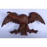 A 19TH CENTURY BAVARIAN BLACK FOREST CARVED WOOD FIGURE OF A BIRD with wings outstretched. 34 cm x 2