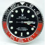 A contemporary Rolex type wall clock 34cm.