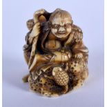 A CHARMING 19TH CENTURY JAPANESE MEIJI PERIOD CARVED IVORY NETSUKE modelled as a scholar swatting a