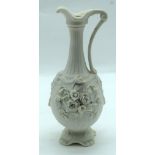 A Parion ware wine pourer decorated with flowers 26cm.
