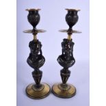 A PAIR OF 19TH CENTURY FRENCH BRONZE PORTRAIT CANDLESTICKS modelled upon polished pedestals. 26 cm h