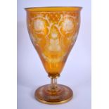 A 19TH CENTURY BOHEMIAN AMBER GLASS GOBLET VASE engraved with foliage and vines. 21 cm x 10 cm.
