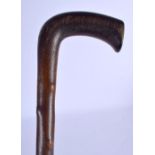 A VERY RARE 19TH CENTURY MIDDLE EASTERN CARVED RHINOCEROS HORN FULL LENGTH WALKING CANE of fabulous