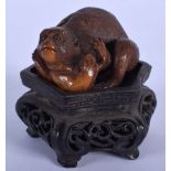 AN EARLY 20TH CENTURY JAPANESE MEIJI PERIOD CARVED TAGUA NUT OKIMONO modelled as a monkey clutching