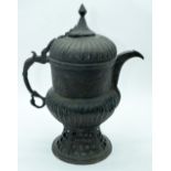 An 18th Century Islamic open work bronze Samovar heavily embossed with a floral pattern 38cm.