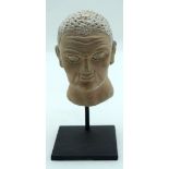 A small Middle Eastern Clay head on a stand 13cm.(2)