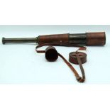 A 3 drawer bronze telescope with a leather case 73cm.