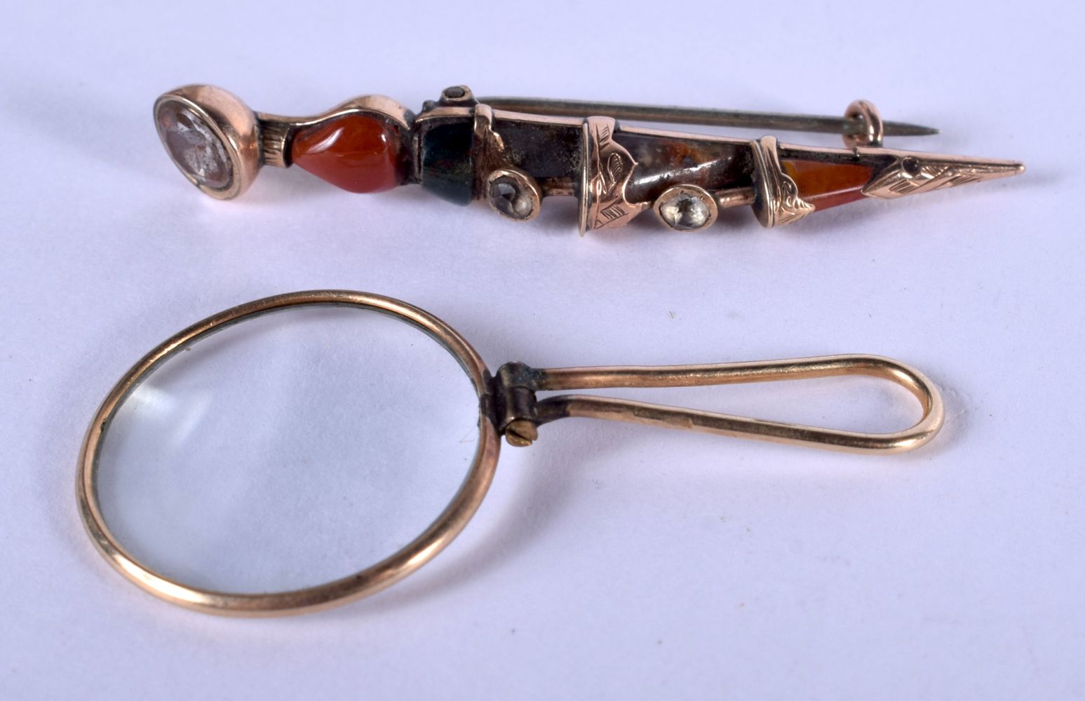 A SCOTTISH GOLD AND AGATE DIRK DAGGER BROOCH and another. 5 grams. (2)