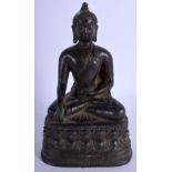 A 19TH CENTURY SOUTH EAST ASIAN BRONZE FIGURE OF A SEATED BUDDHA modelled upon a lotus capped triang