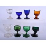 EIGHT GEORGE III GLASS EYE BATHS. Largest 7 cm high. (8)