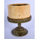 A MID 19TH CENTURY EUROPEAN CARVED IVORY AND BRONZE PEDESTAL BASE decorated with foliage. 12 cm x 8
