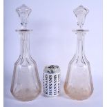 A PAIR OF 19TH CENTURY ENGLISH CUT GLASS DECANTERS AND COVERS engraved with birds and vines. 34 cm h