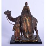 A LATE 19TH CENTURY AUSTRIAN COLD PAINTED MODEL OF A CAMEL depicting a carpet seller upon a shaped b